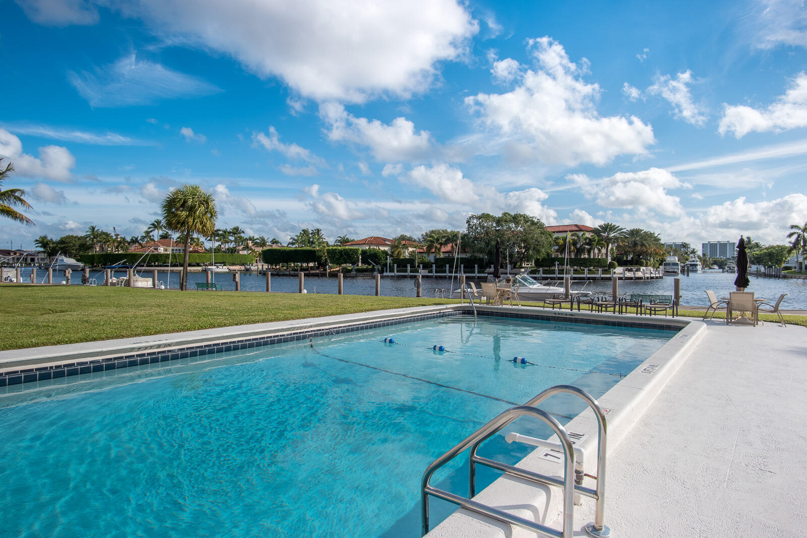 a view of a swimming pool with a yard