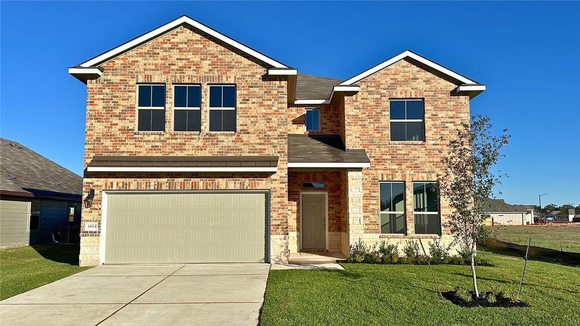 front view of a house with a yard