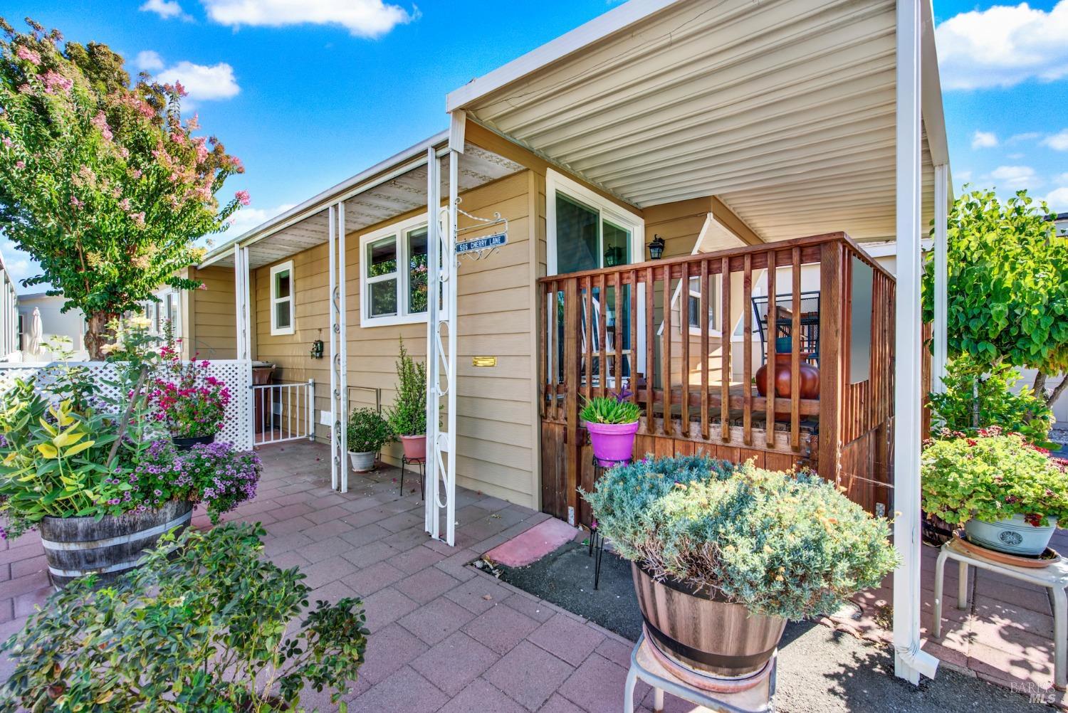 a front view of a house with potted plants