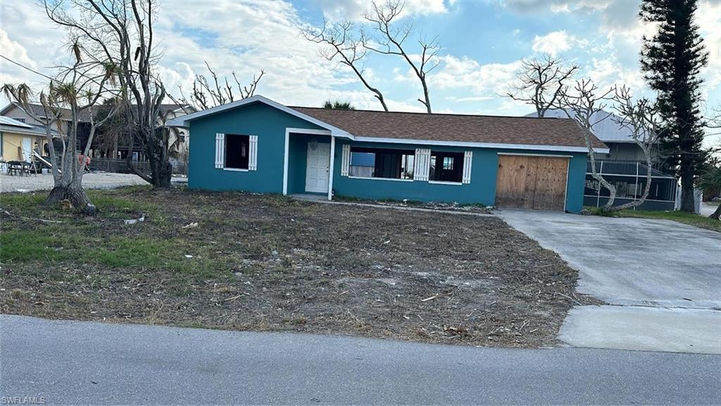 a house that has a tree in front of it