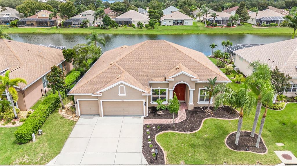 an aerial view of a house with swimming pool and outdoor seating