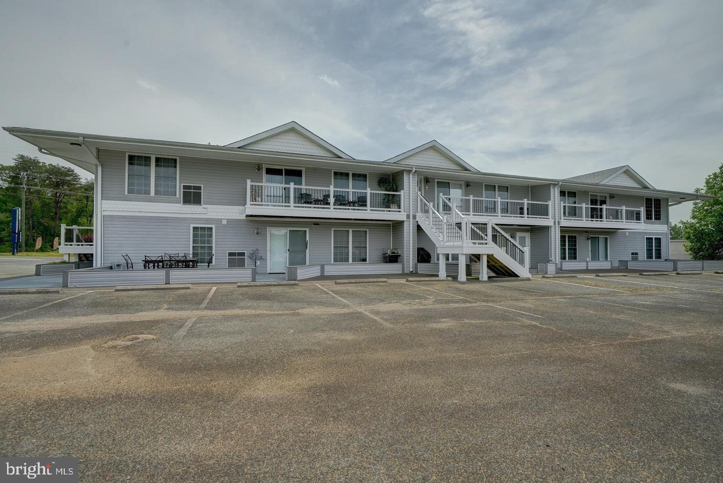 a front view of a house with a yard and balcony