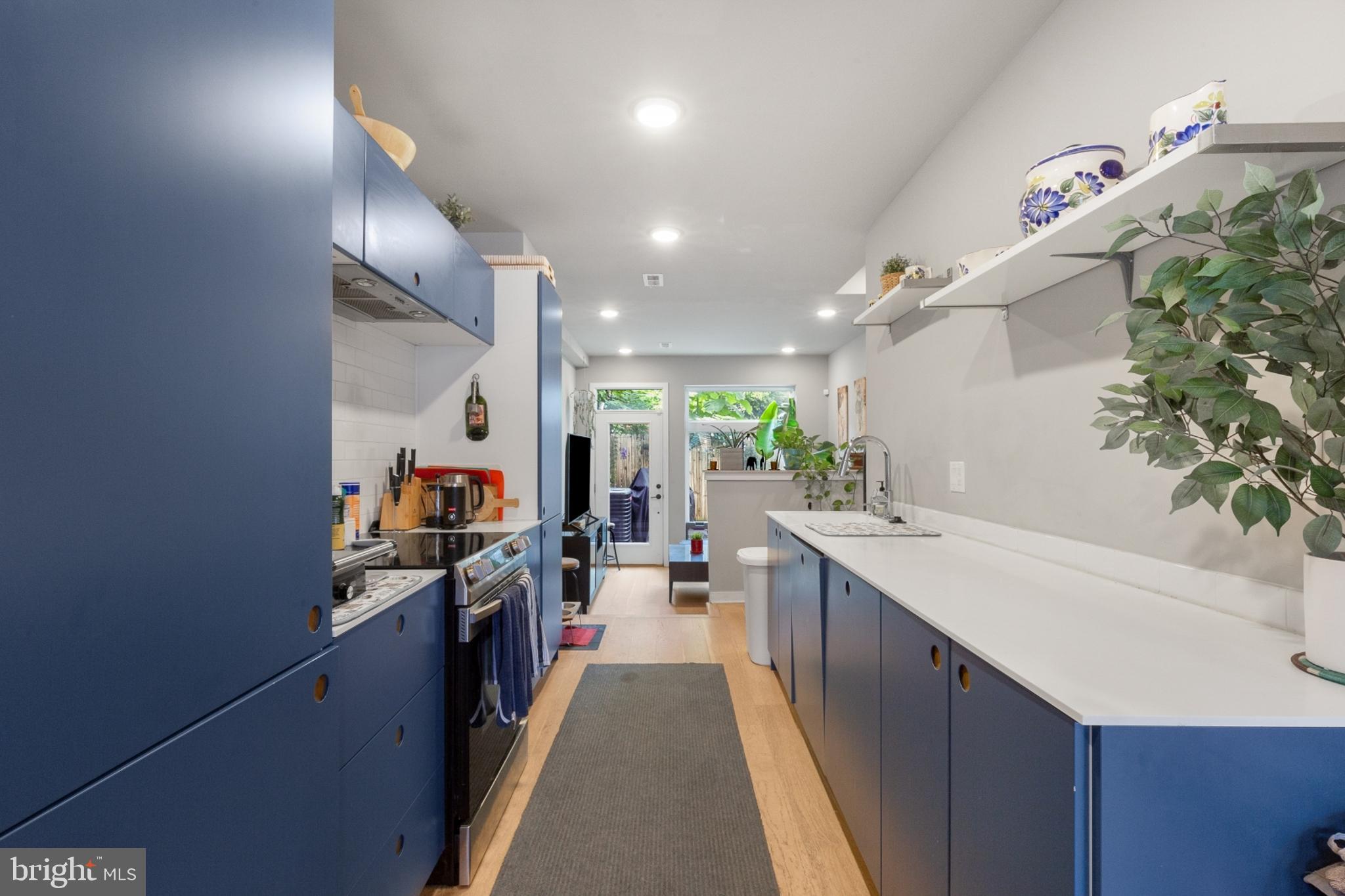 a kitchen with stainless steel appliances a sink stove and cabinets