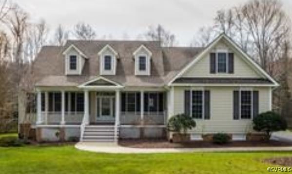 View of front of house with a front lawn and cover