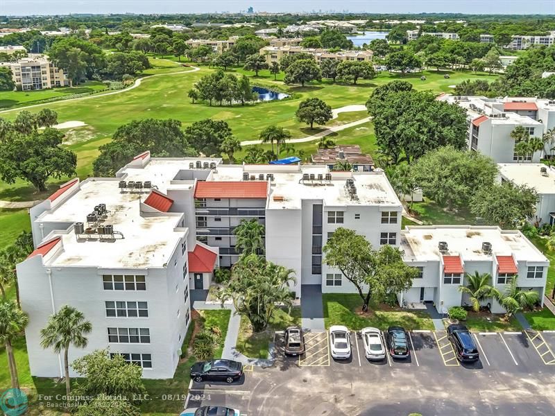 an aerial view of residential houses with outdoor space and street view