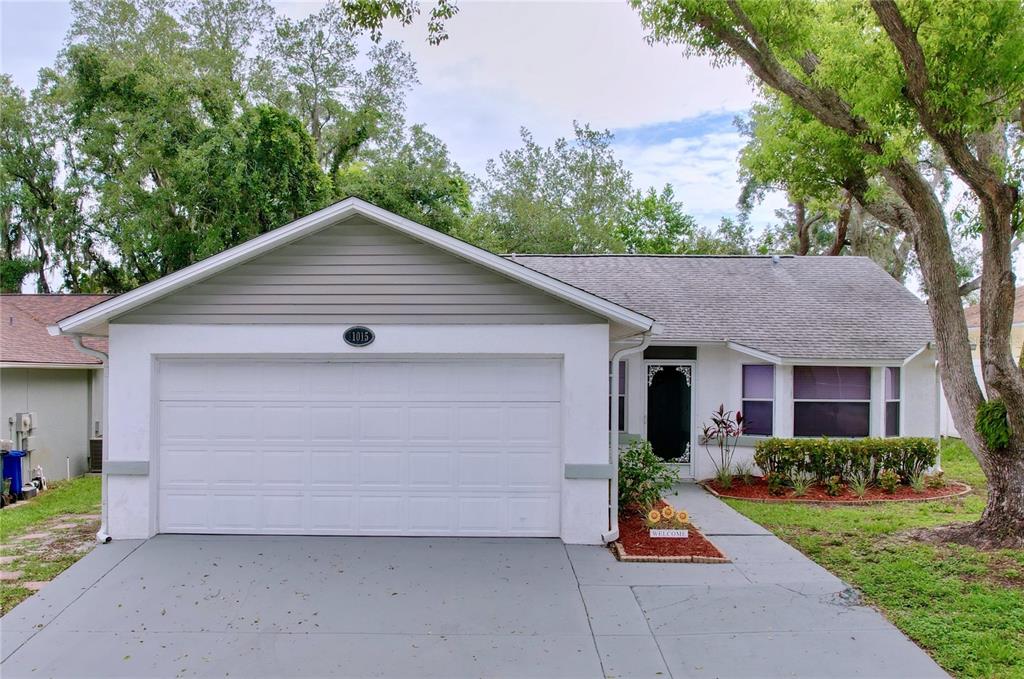 a front view of house with garage and yard