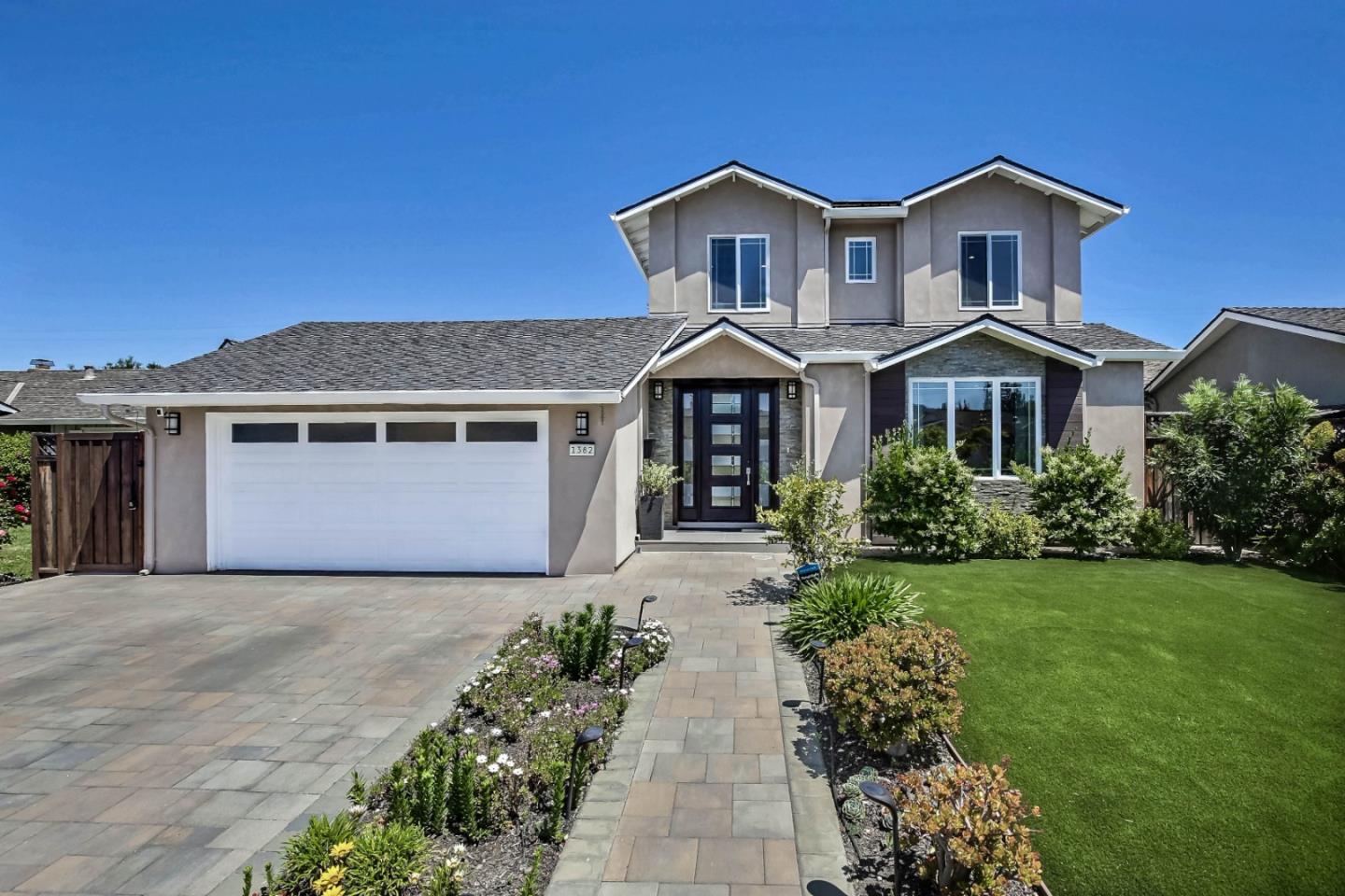 a front view of a house with a garden