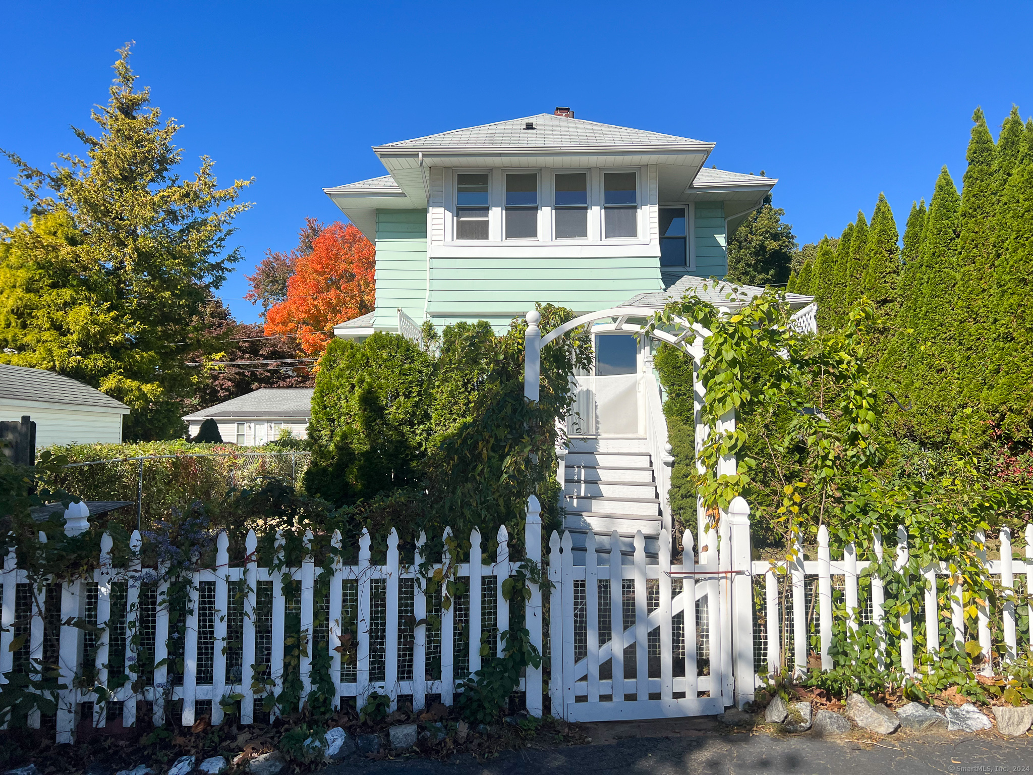 a front view of a house with a garden