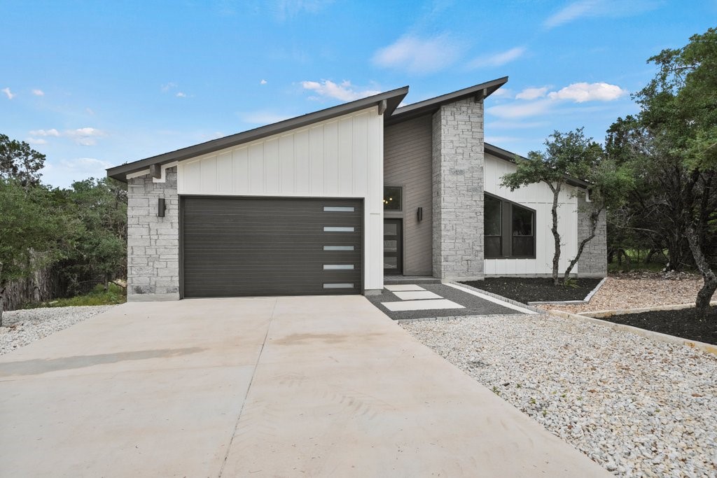 a front view of a house with a yard and garage