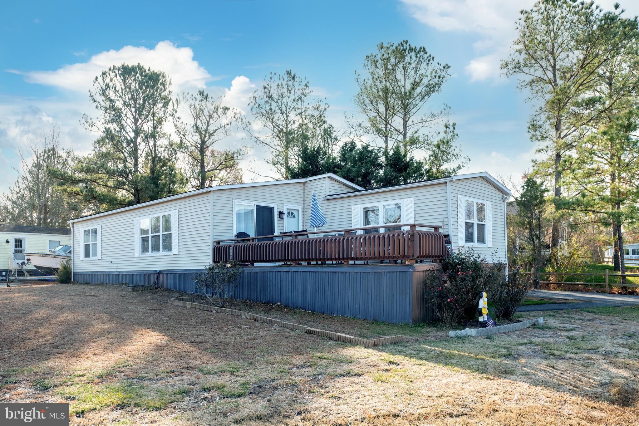 a view of a house with a yard and large tree