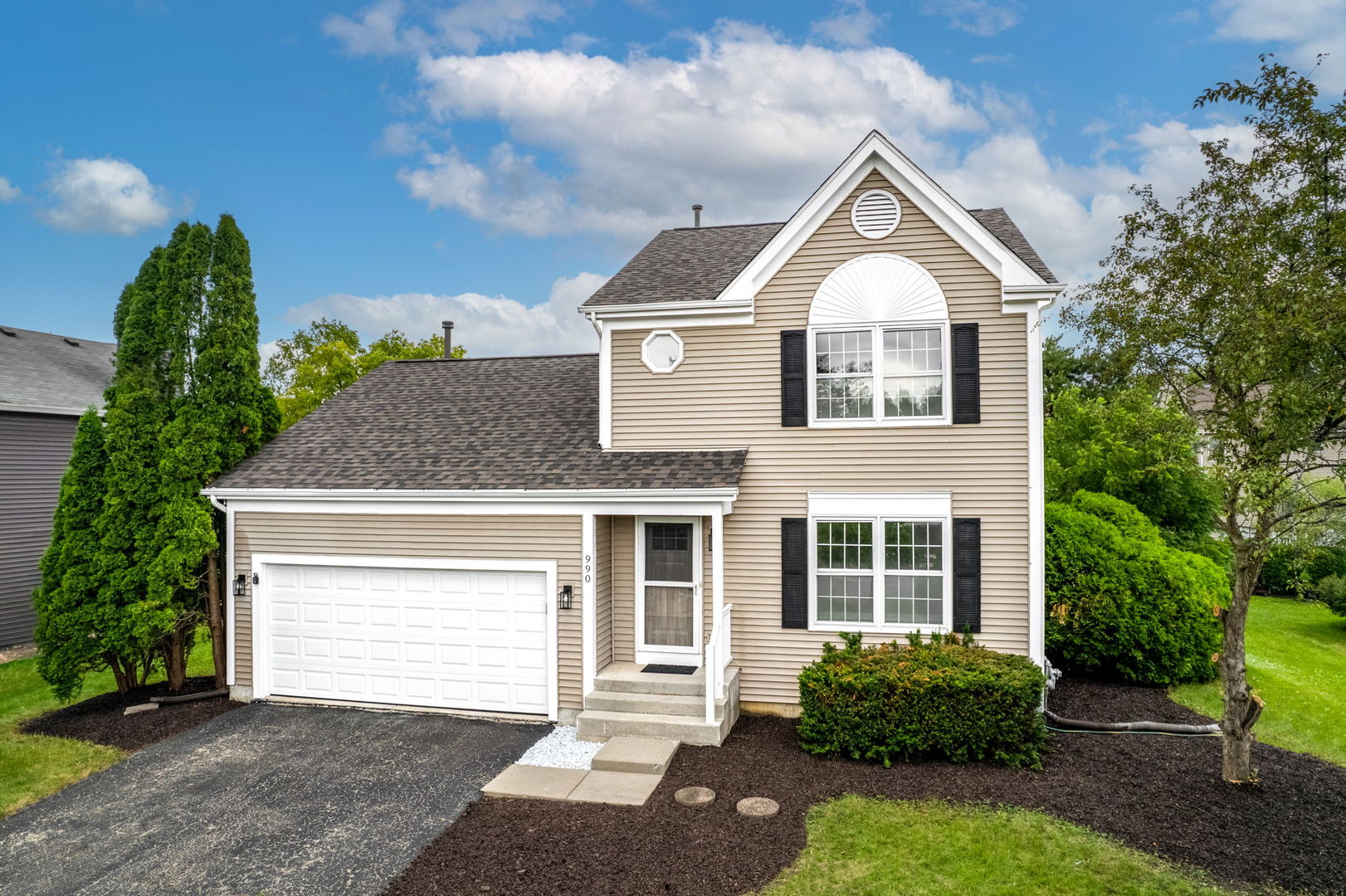 a front view of a house with a yard and garage