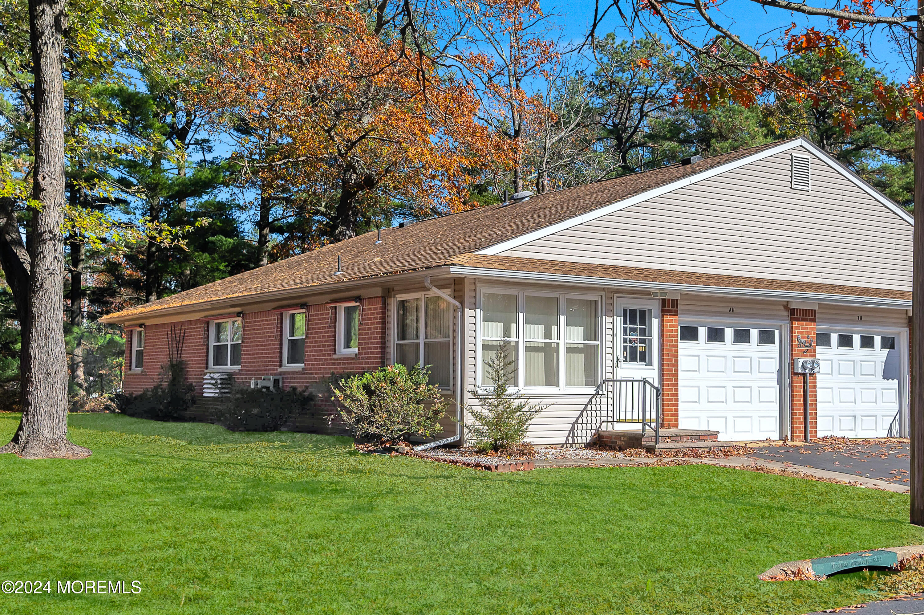 a front view of a house with a garden and yard