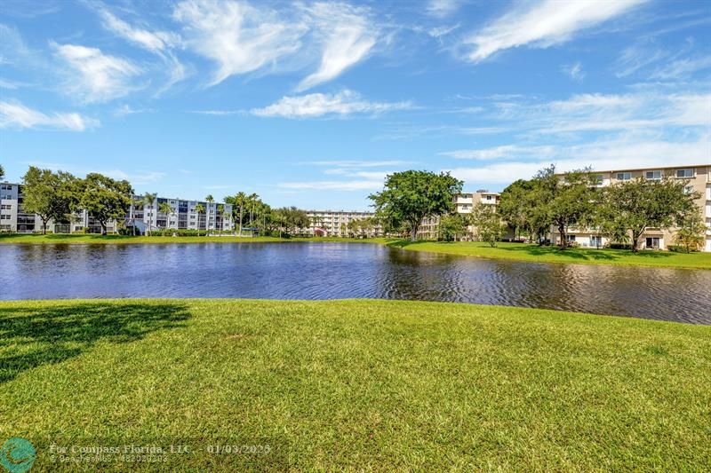 a view of a lake with houses in the back