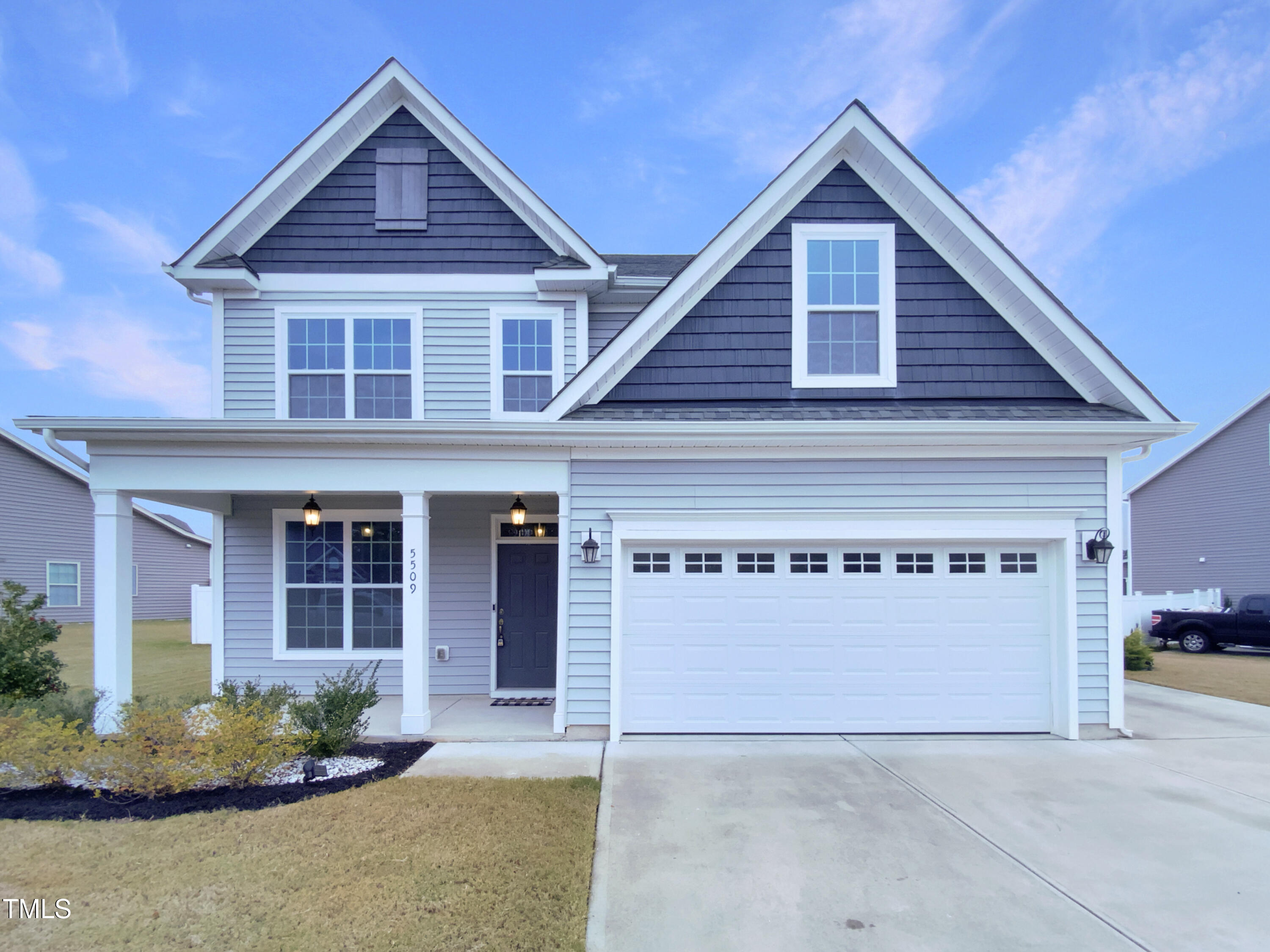 a front view of a house with garage