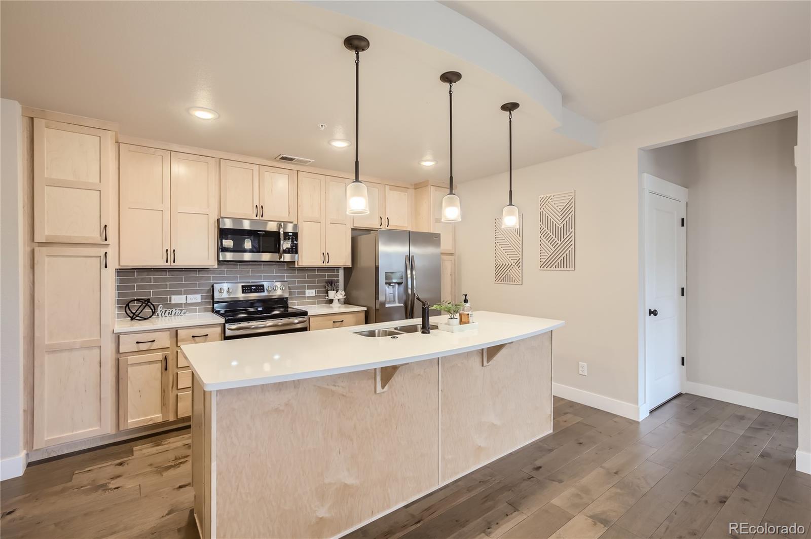 a kitchen with stainless steel appliances and white cabinets