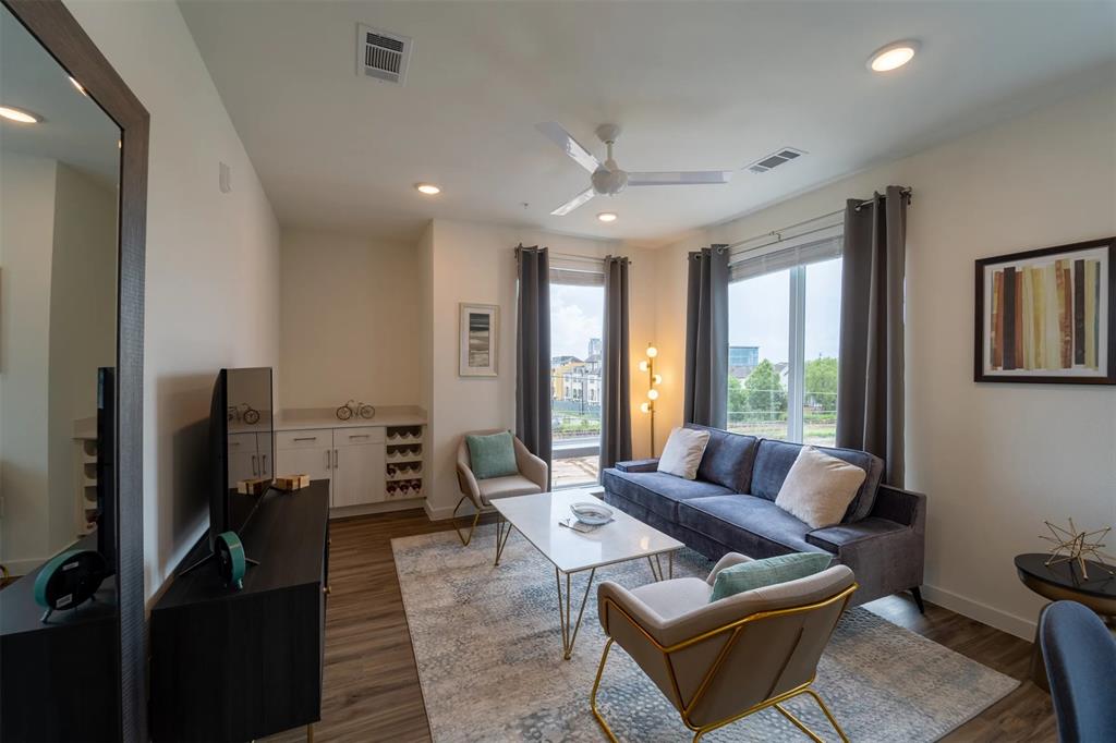 a living room with furniture fireplace and a large window