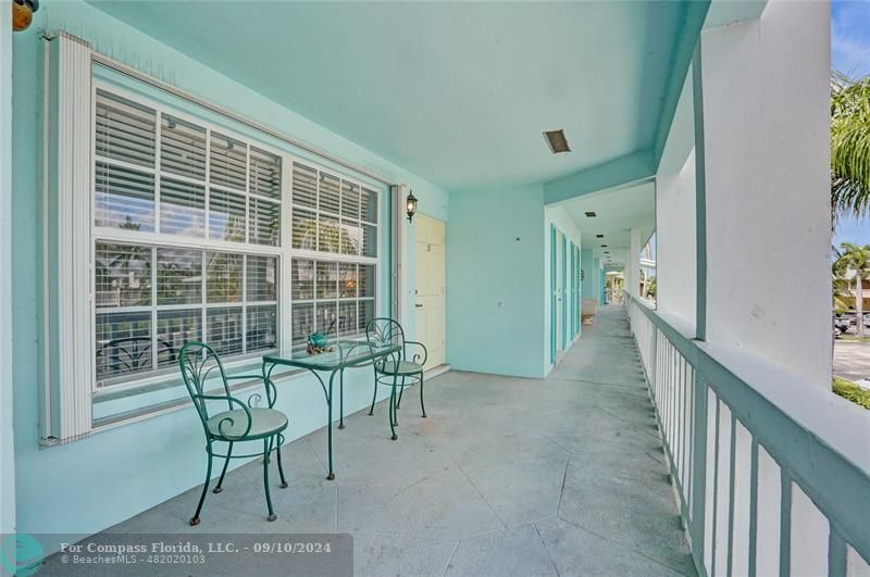 a view of a room with furniture and windows