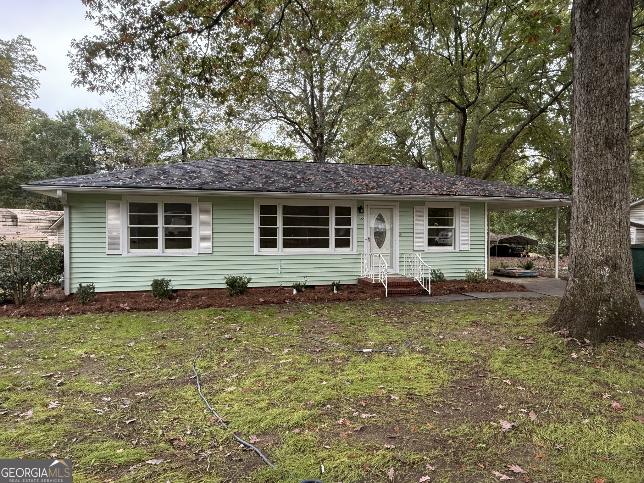 a house that has a tree in front of it