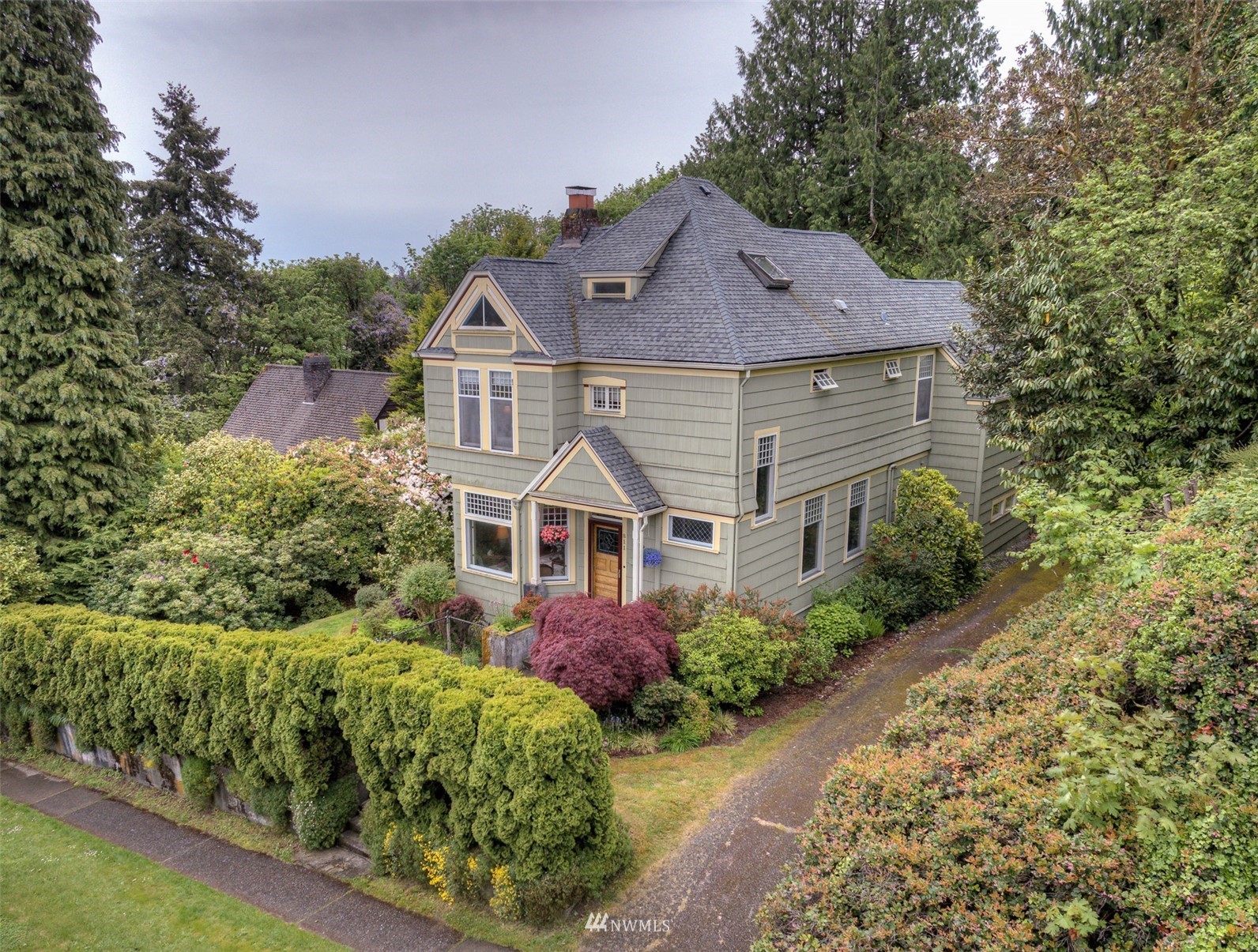 a front view of a house with a garden