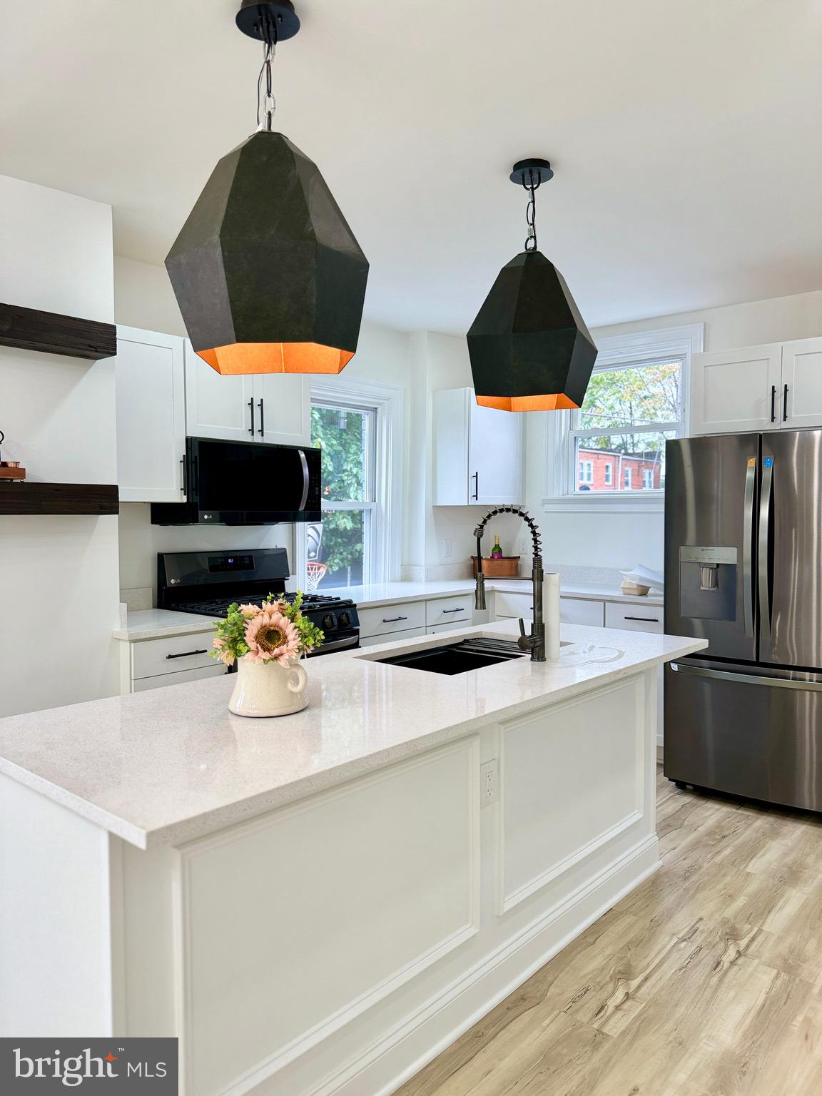 a kitchen with a sink a stove and a microwave