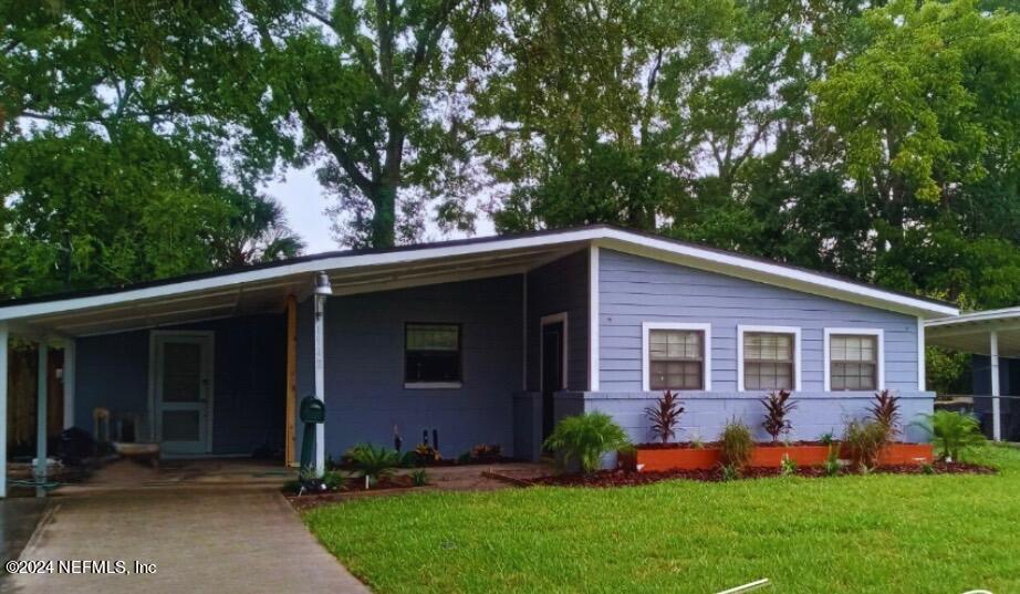 a front view of house with yard and green space