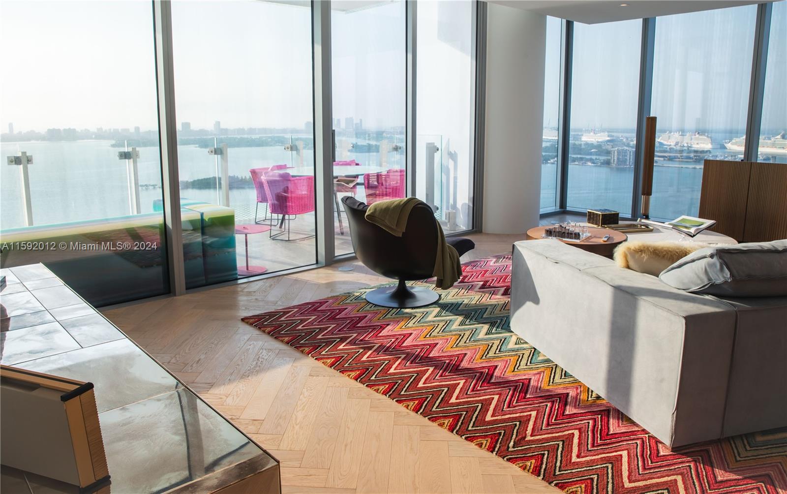 a living room with furniture and a floor to ceiling window