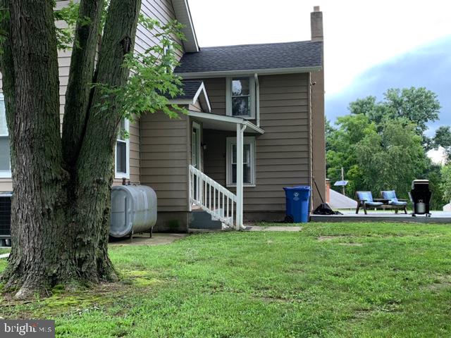 a view of a house with a yard and sitting area