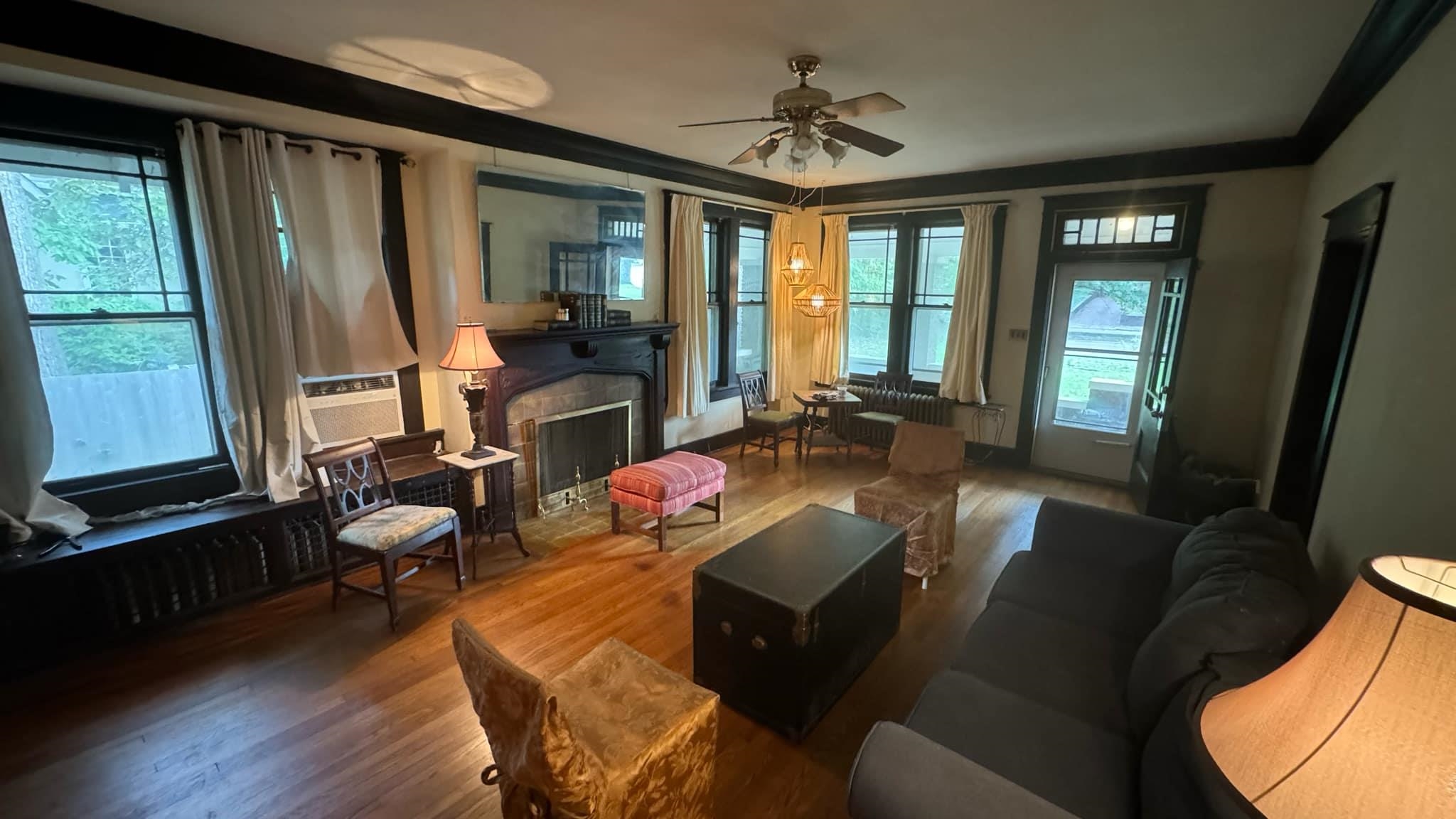 a living room with furniture and large windows