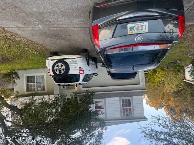 a car parked in the grass of a house