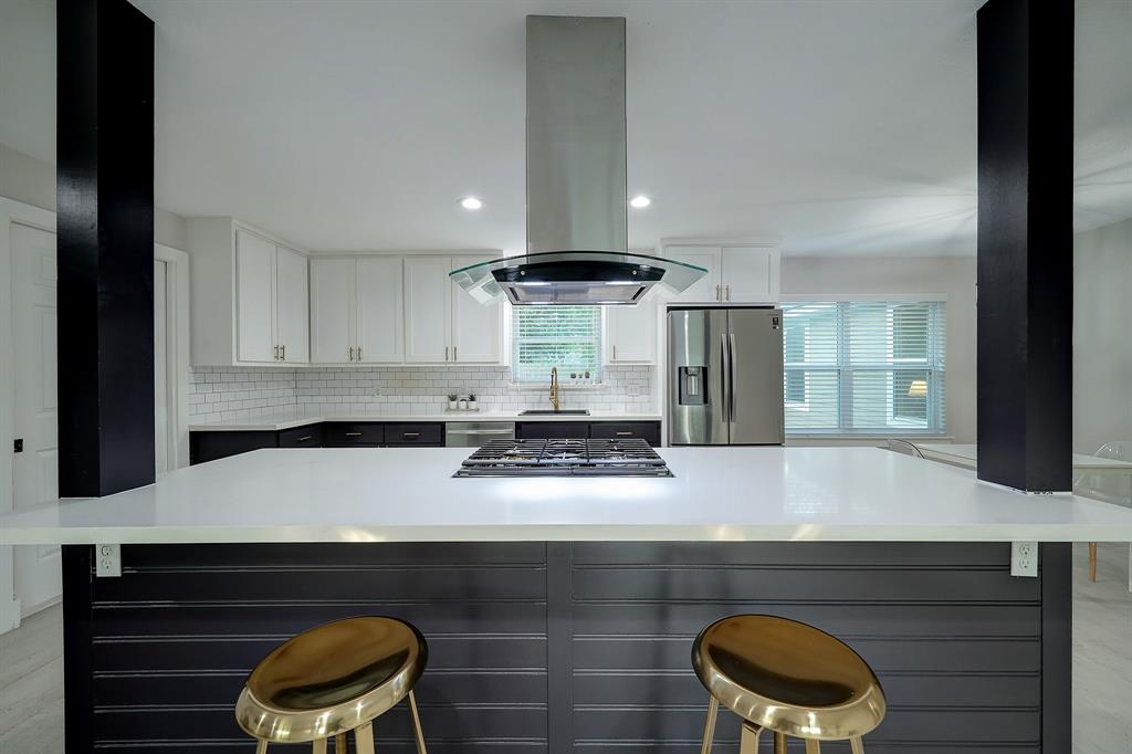 a kitchen with stainless steel appliances granite countertop a stove and a refrigerator