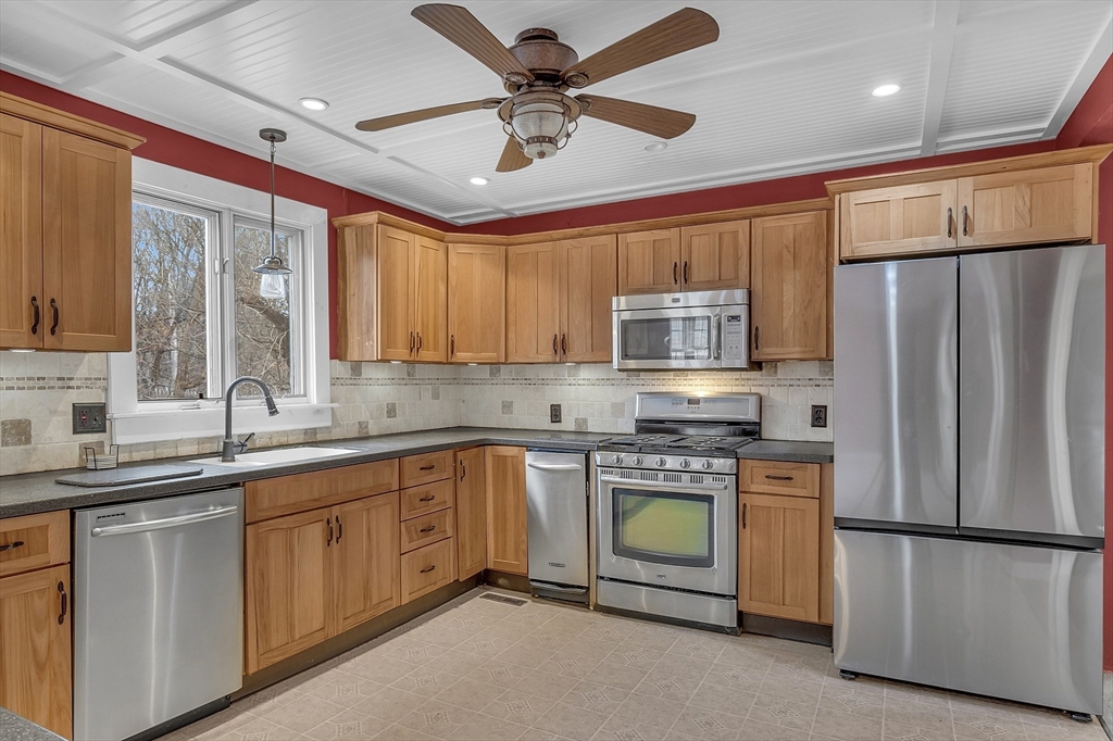 a kitchen with stainless steel appliances a refrigerator sink and cabinets