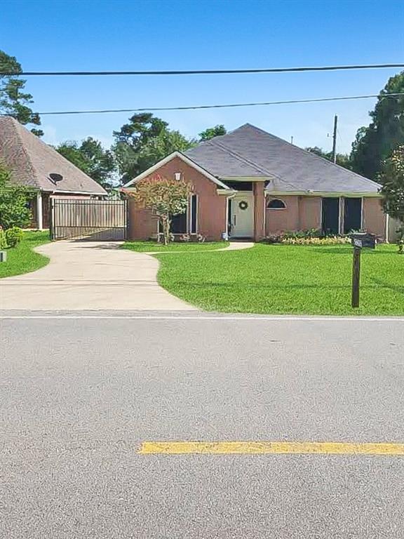 a front view of house with yard and green space