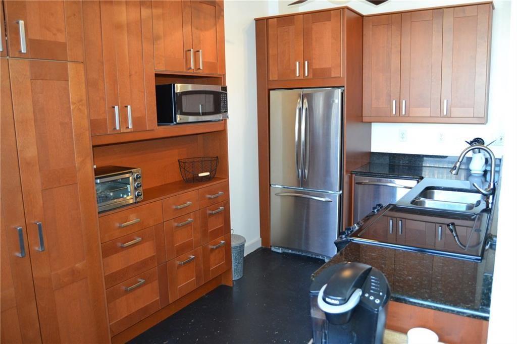 a kitchen with refrigerator and cabinets