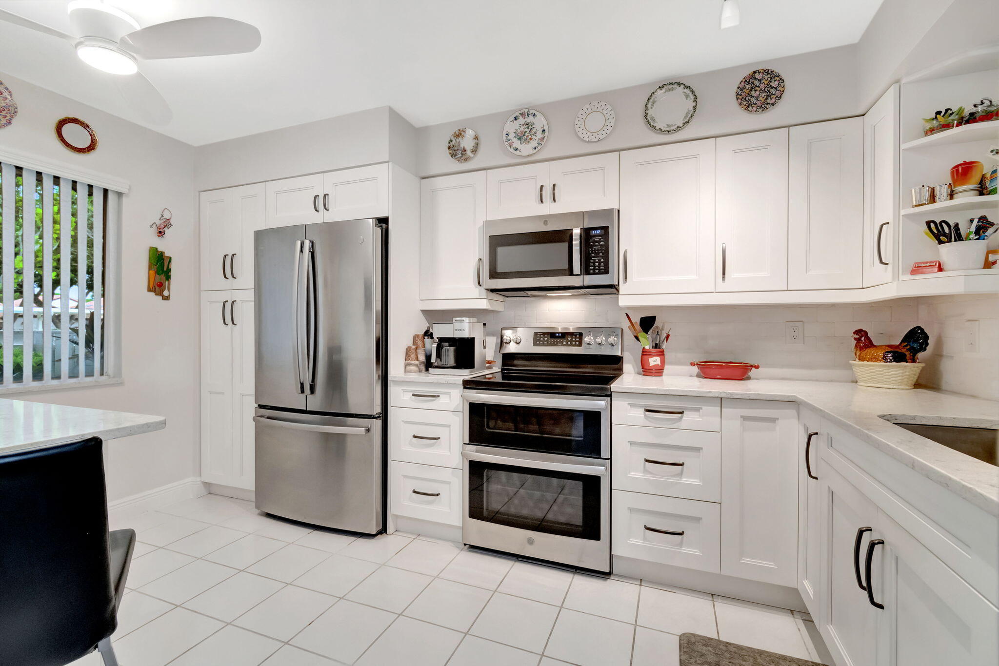 a kitchen with cabinets stainless steel appliances and a window