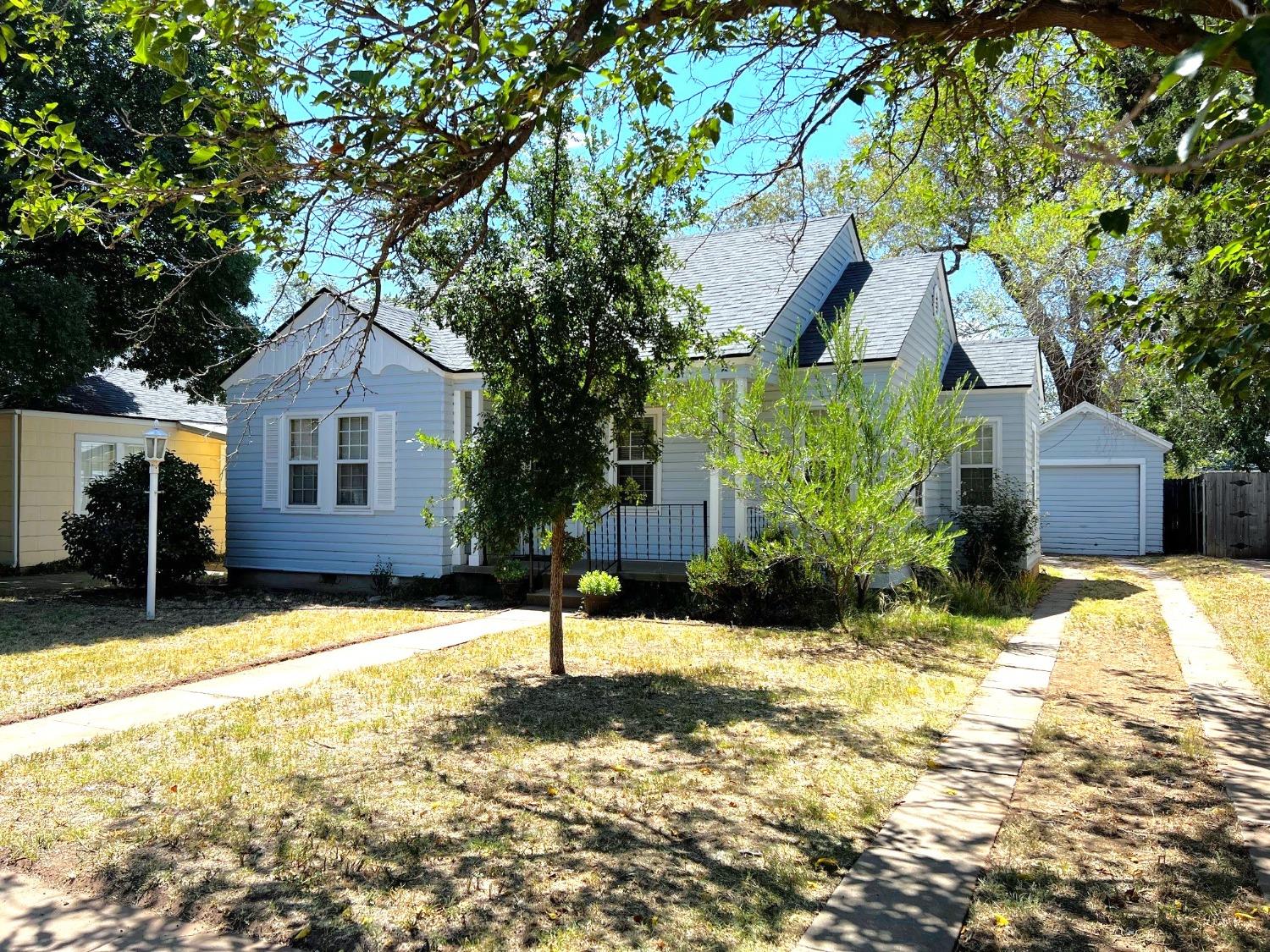 a front view of a house with a yard covered in snow