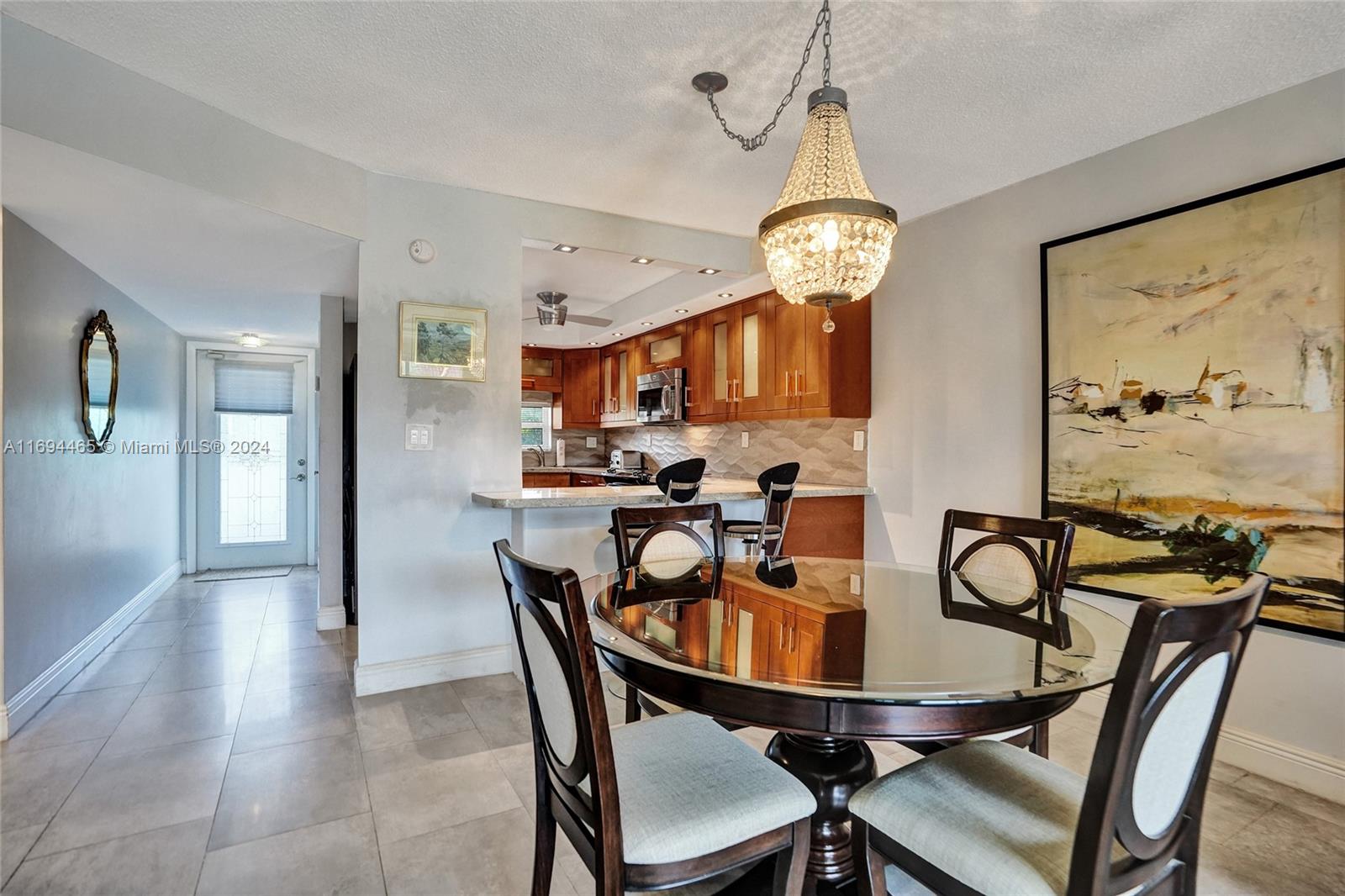 a view of a dining room with furniture and chandelier