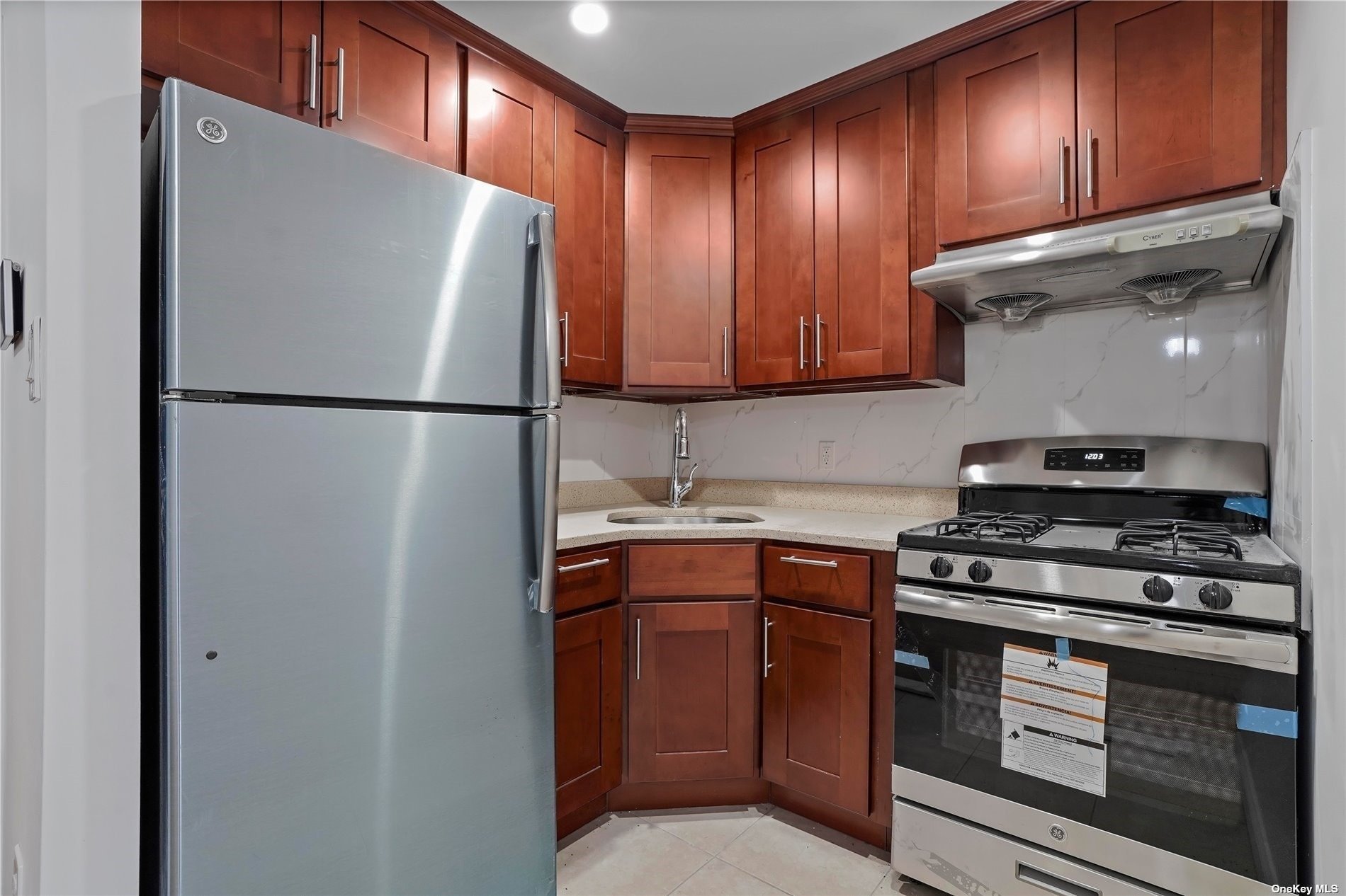 a kitchen with a refrigerator sink and cabinets