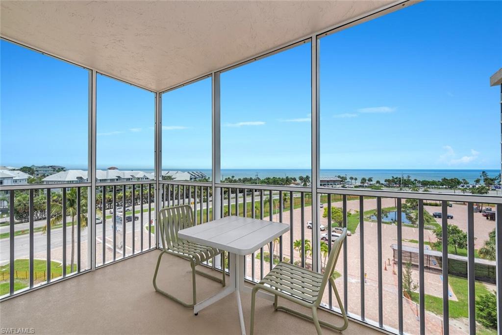 a view of a balcony with chairs and a table