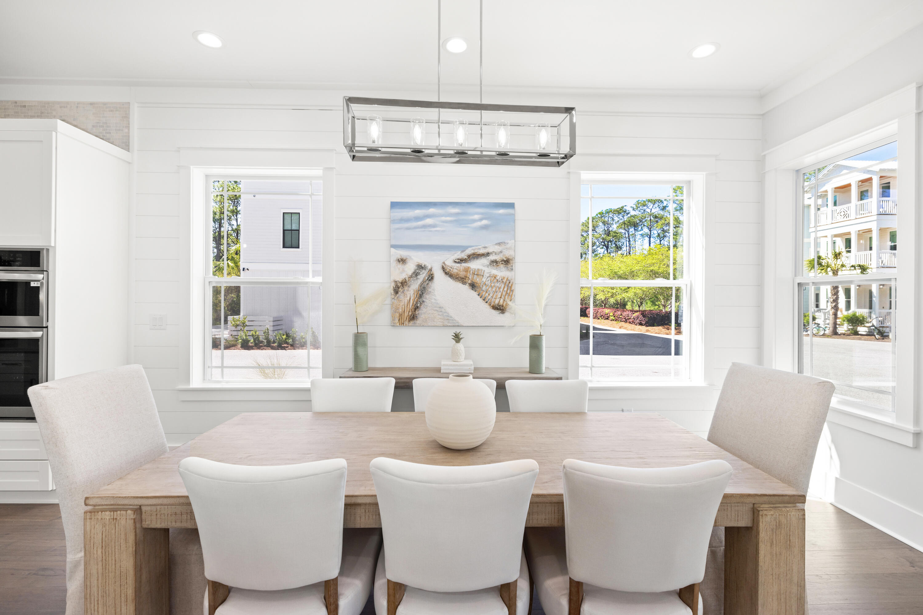 a dining room with furniture a chandelier and window