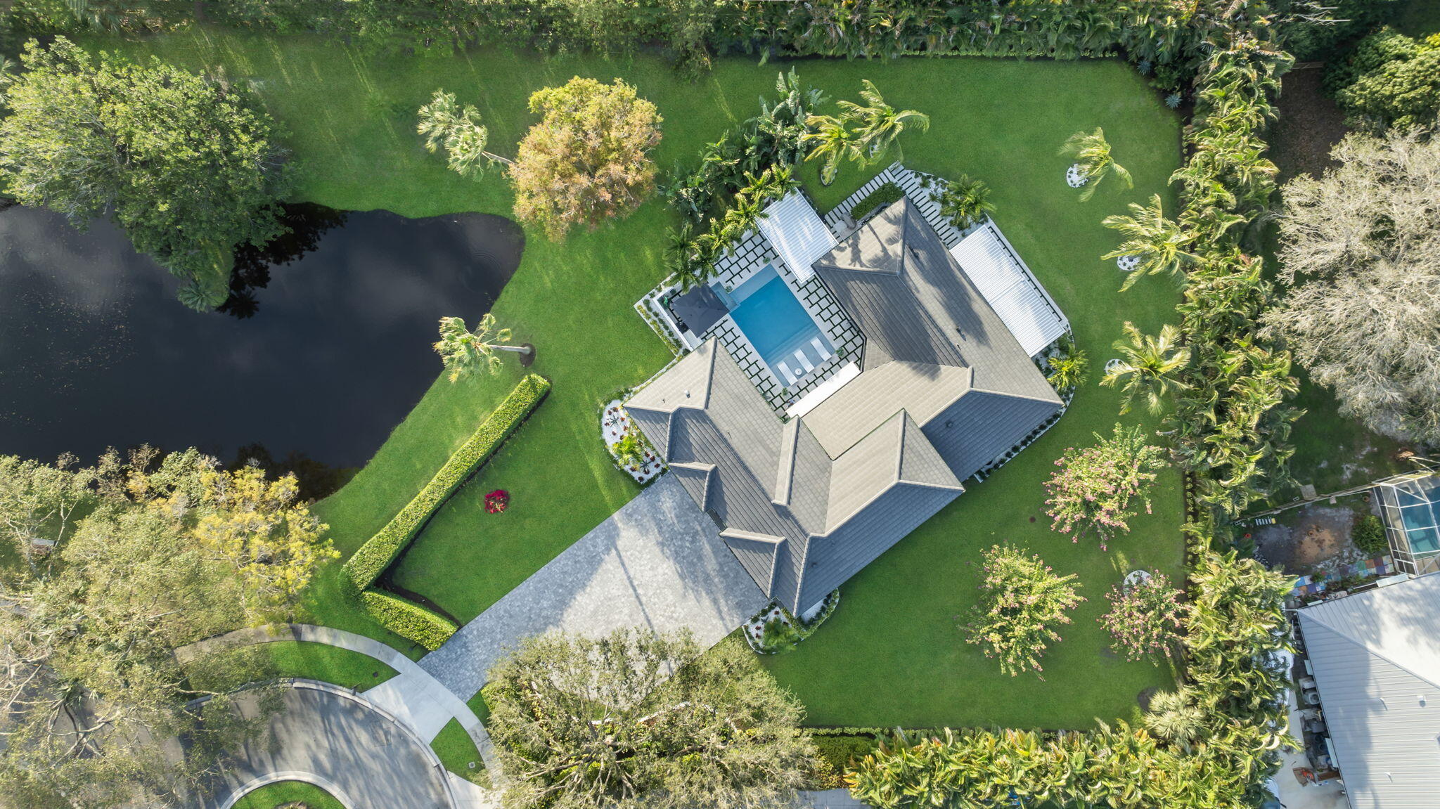 an aerial view of a house with a yard and lake view