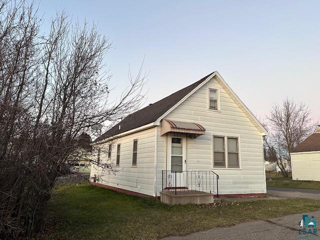 Bungalow-style home with a lawn