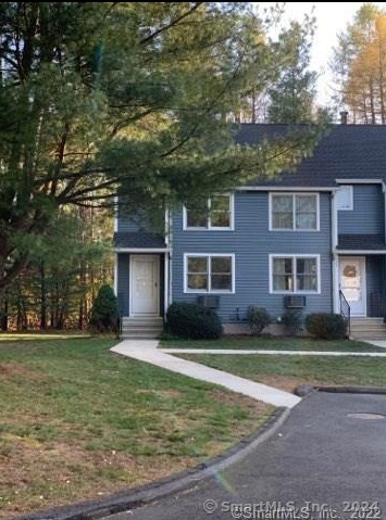 a view of a yard in front of a brick house