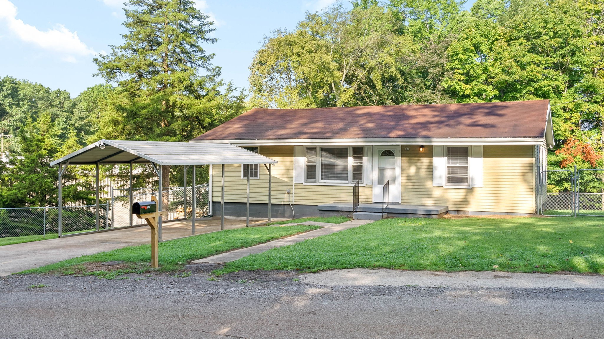 a front view of a house with a yard table and chairs