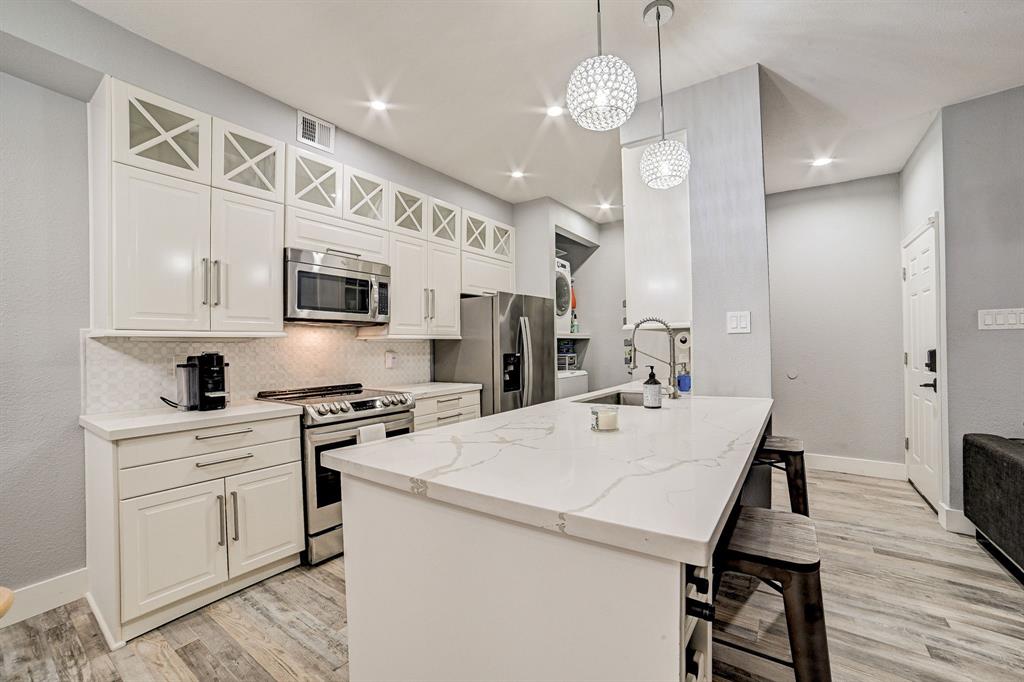 a kitchen with a stove a sink and a refrigerator