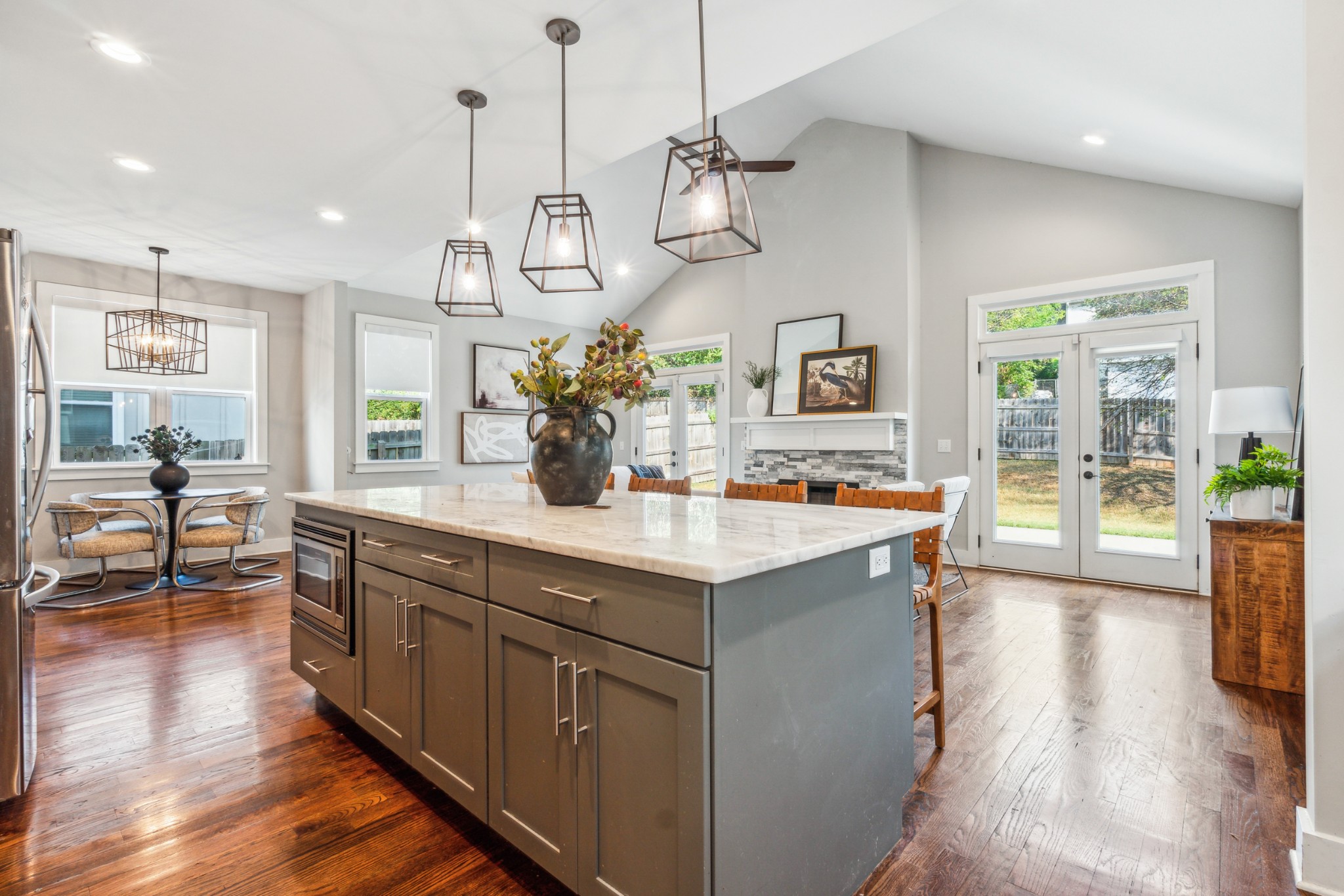 a kitchen with stainless steel appliances granite countertop a sink a stove and a wooden floors