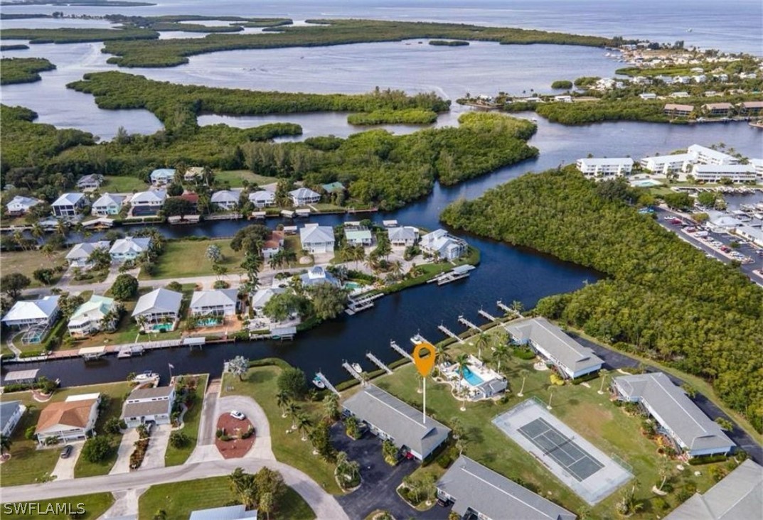 an aerial view of lake and residential houses with outdoor space