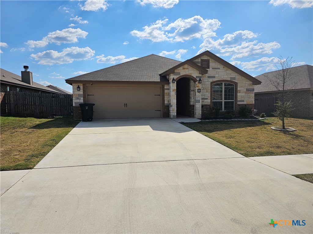 a front view of a house with yard