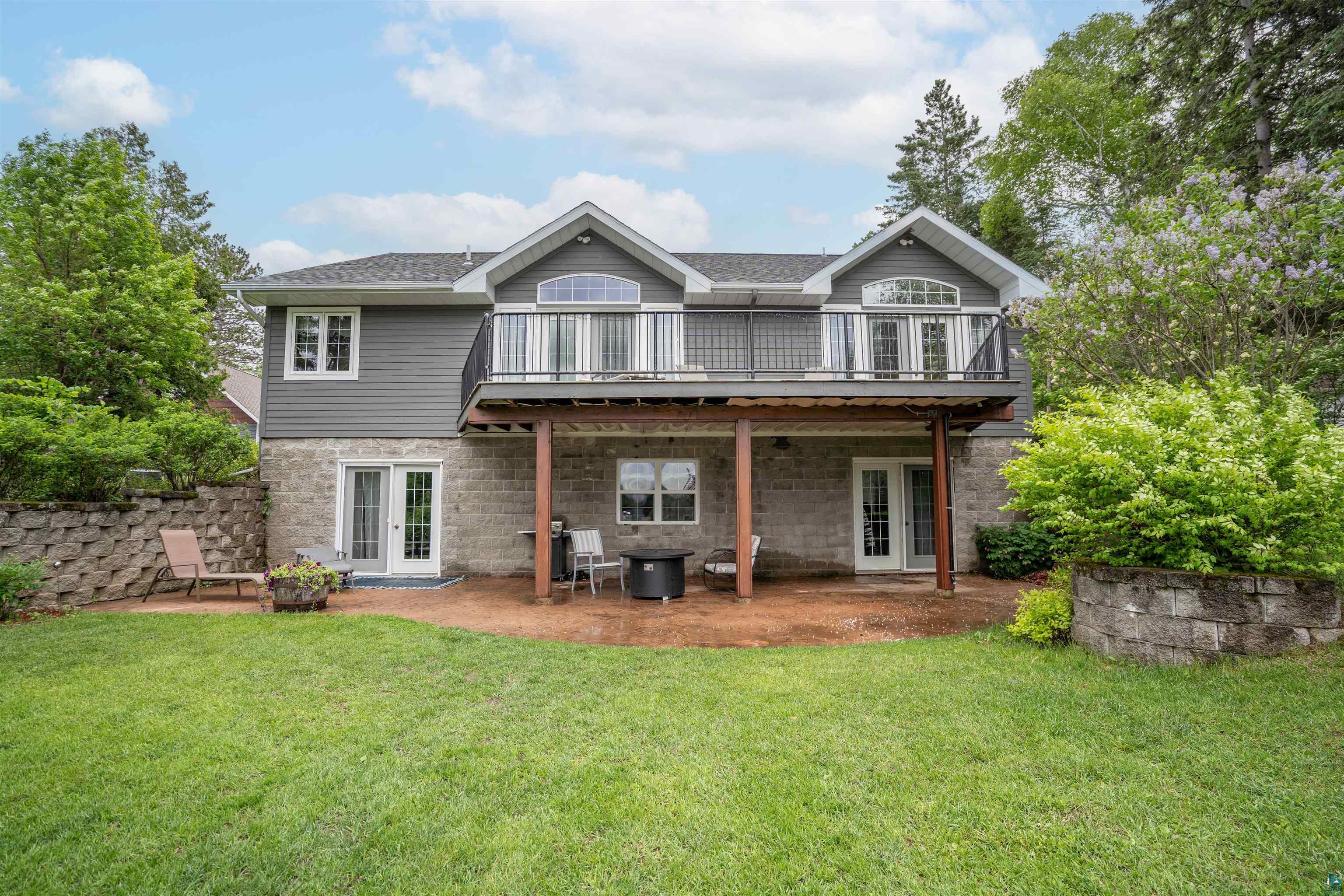 Rear view of house featuring french doors and a lawn