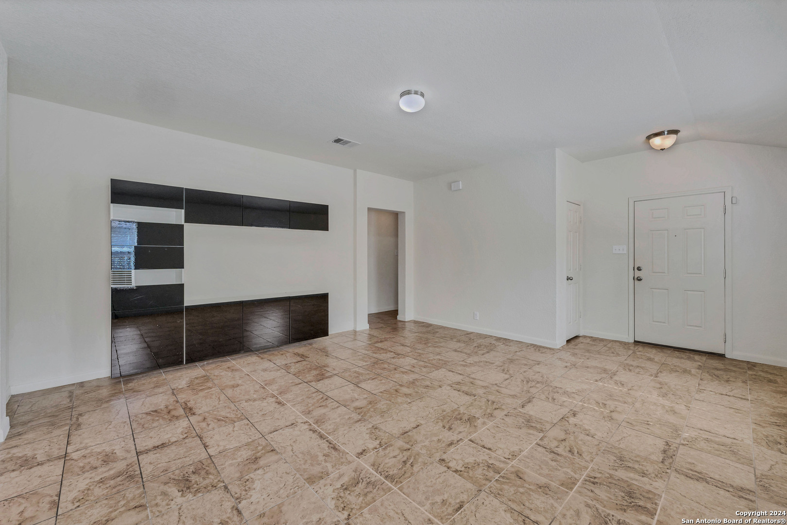 a view of empty room with a fireplace