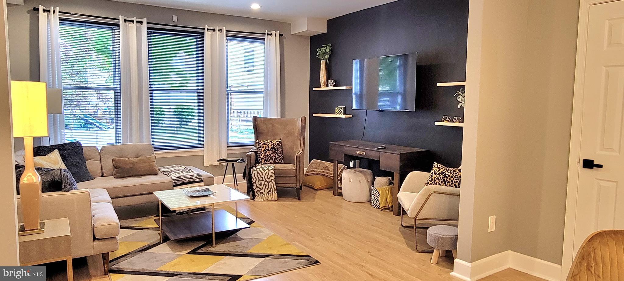 a living room with furniture and large windows